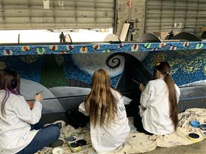 students painting snow plow